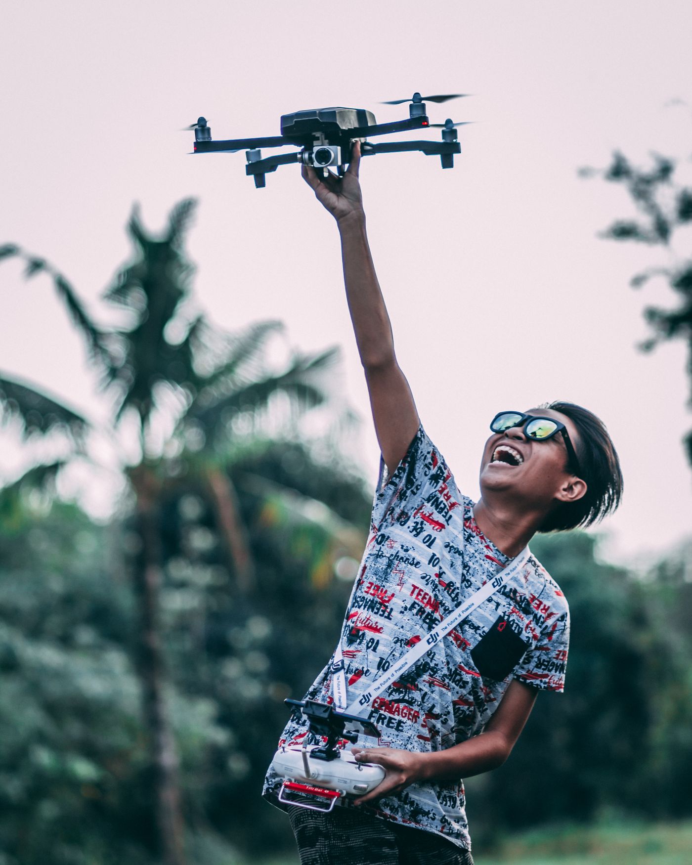 Operator flying a drone with a gimbal-mounted payload