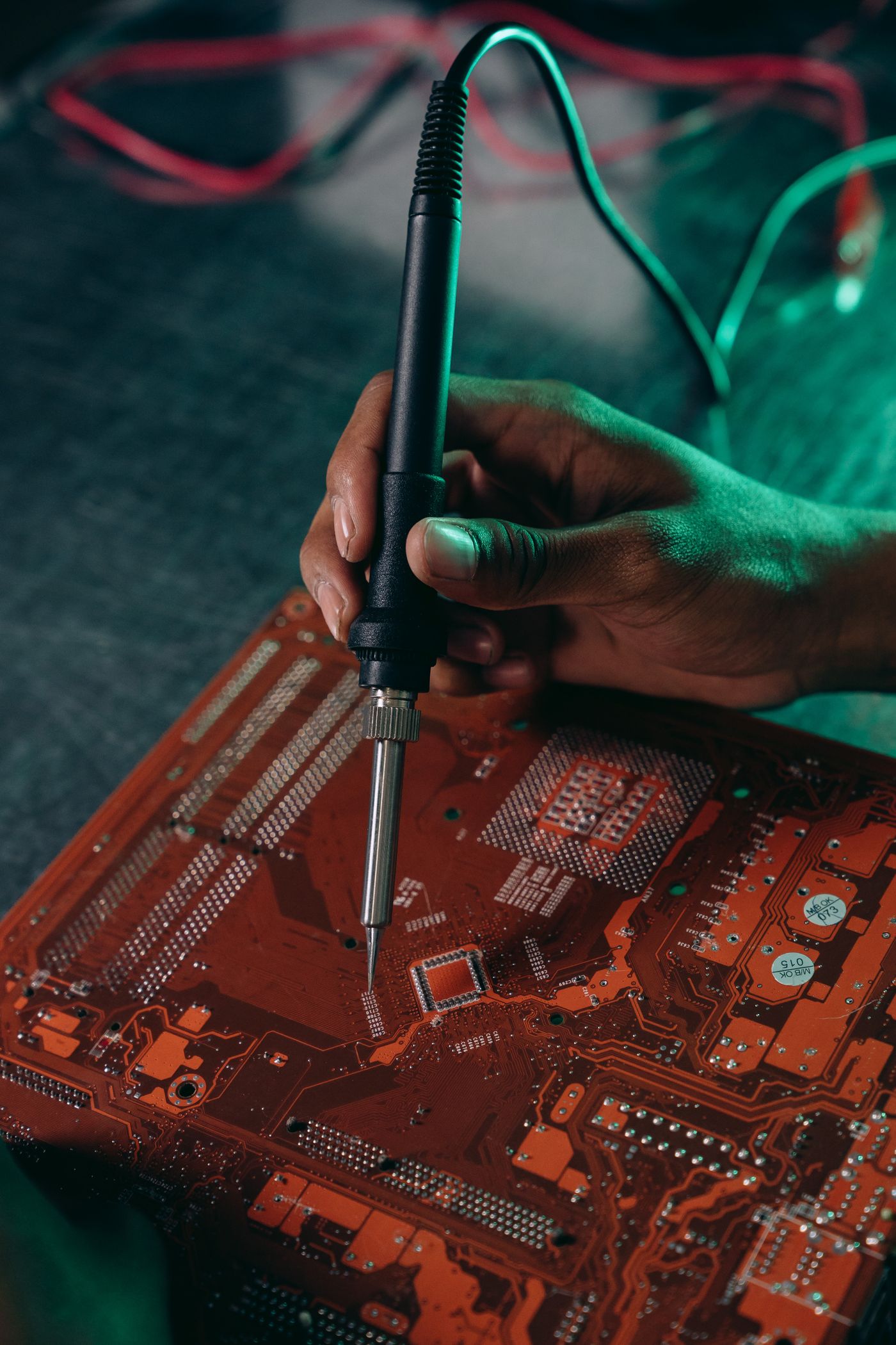 Technician soldering components on a circuit board